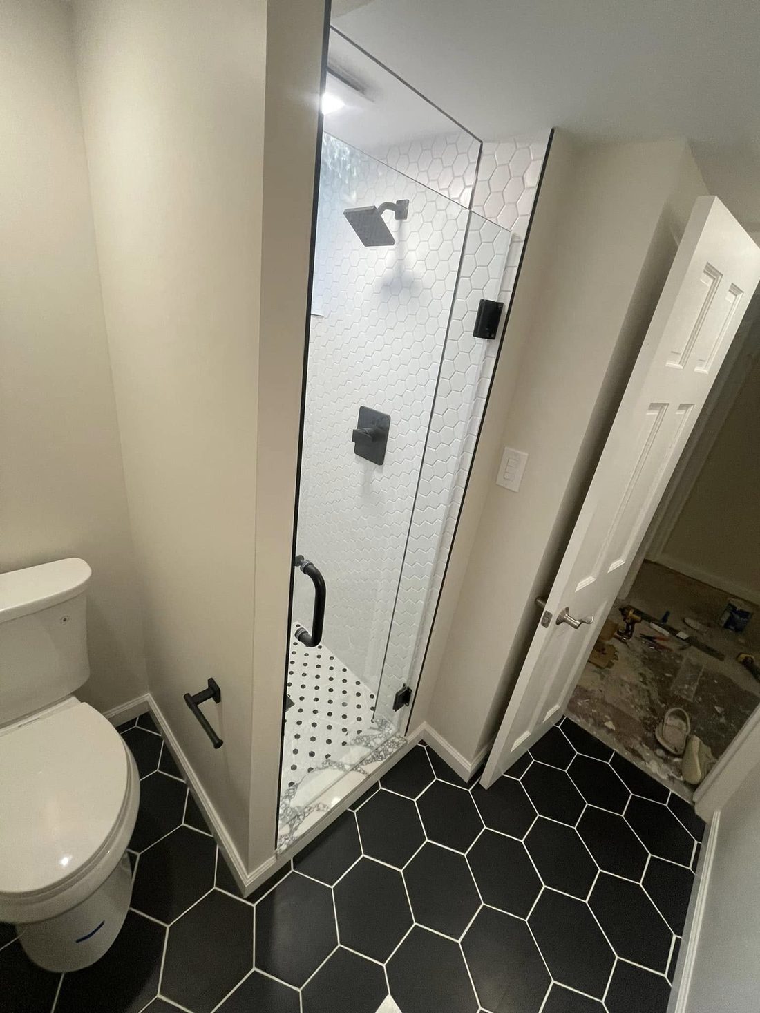 Walk-in shower with black hex tile