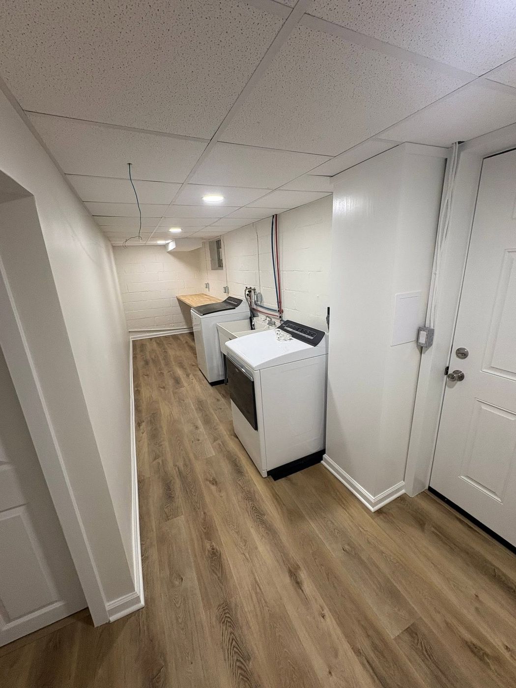 Finished basement hallway with new flooring