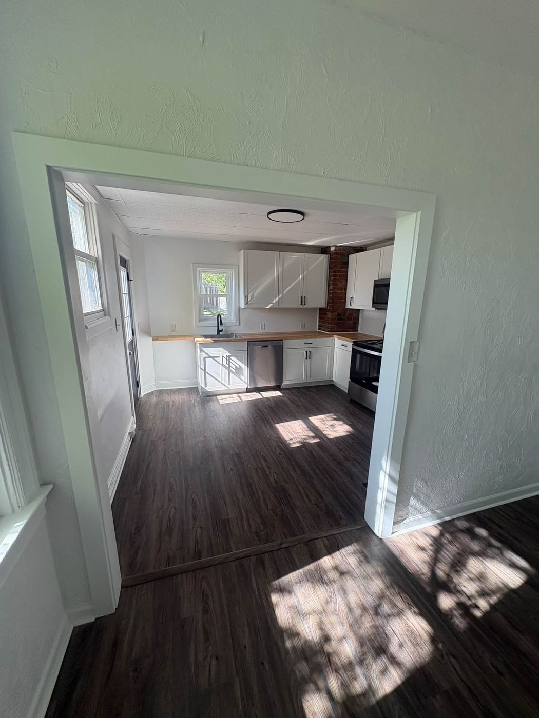 Remodeled kitchen seen through an opened doorway